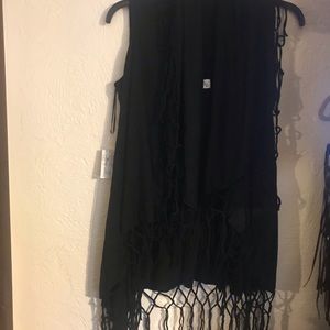 Black vest with fringe all around it